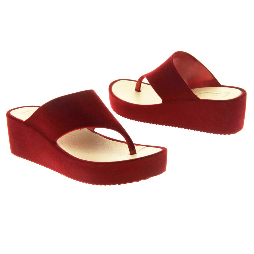 Womens Red Wedge Sandals - Red velvet shoes with 2 inch wedge heels and an open toe post design. Both feet facing opposite directions.