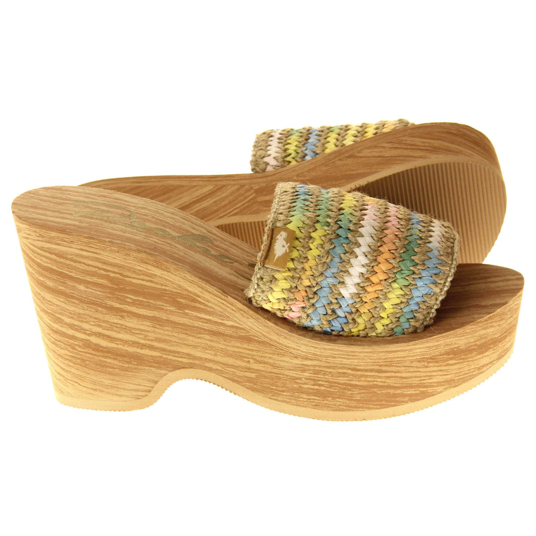 Womens Rocket Dog Wedge Sandals - Light brown wood-effect foam wedge heels with slider / mary jane strap over in a pastel rainbow zig zag design with a hessian weave in-between rows. Right foot side on with left foot outsole showing.
