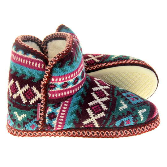 Womens slipper boots. Womens ankle high boot style slippers. Multi coloured knit upper in Aztec pattern. Cream plush faux fur lining. Both feet from a side profile with the left foot on its side behind the the right foot to show the sole.