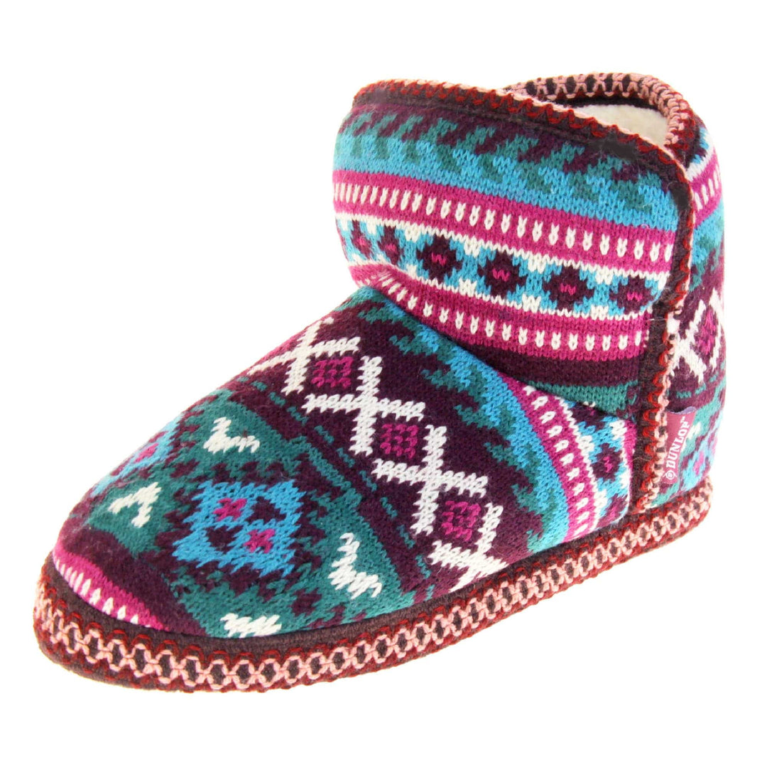 Womens slipper boots. Womens ankle high boot style slippers. Multi coloured knit upper in Aztec pattern. Cream plush faux fur lining. Left foot at an angle.