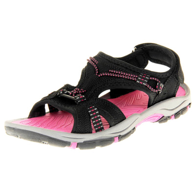 Womens walking sandals - Black suede effect upper with hot pink elasticated strap detailing, and a hook and loop touch fastening backstrap to the ankle. Fuchsia pink comfy insole with grey, black and fuschia flexible outsole with good grips. Left foot at an angle.