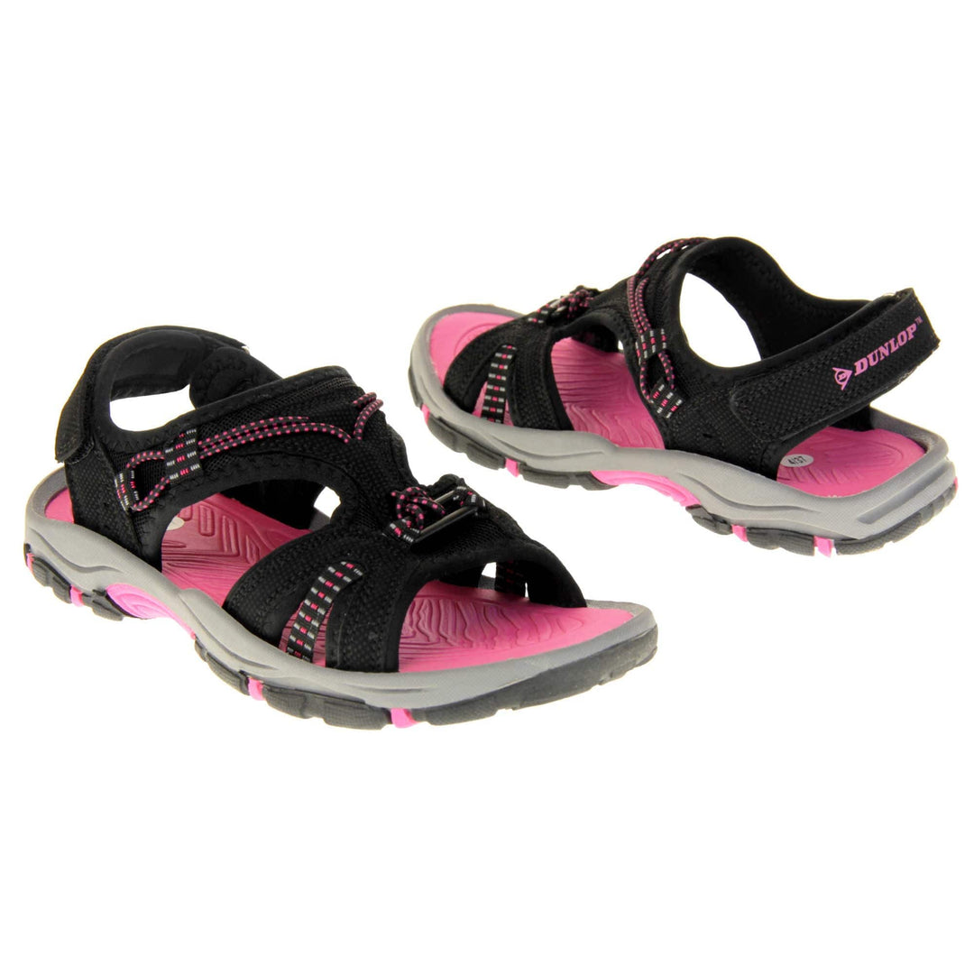 Womens walking sandals - Black suede effect upper with hot pink elasticated strap detailing, and a hook and loop touch fastening backstrap to the ankle. Fuchsia pink comfy insole with grey, black and fuschia flexible outsole with good grips. Both feet facing opposite directions.