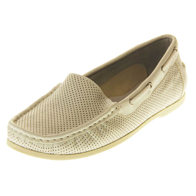 Women's white boat shoes. Loafer style boat shoes with a white faux leather upper and tiny dot cut-outs. White lace detail running around the outside of the collar. Cream leather lining and white sole. Left foot at an angle.