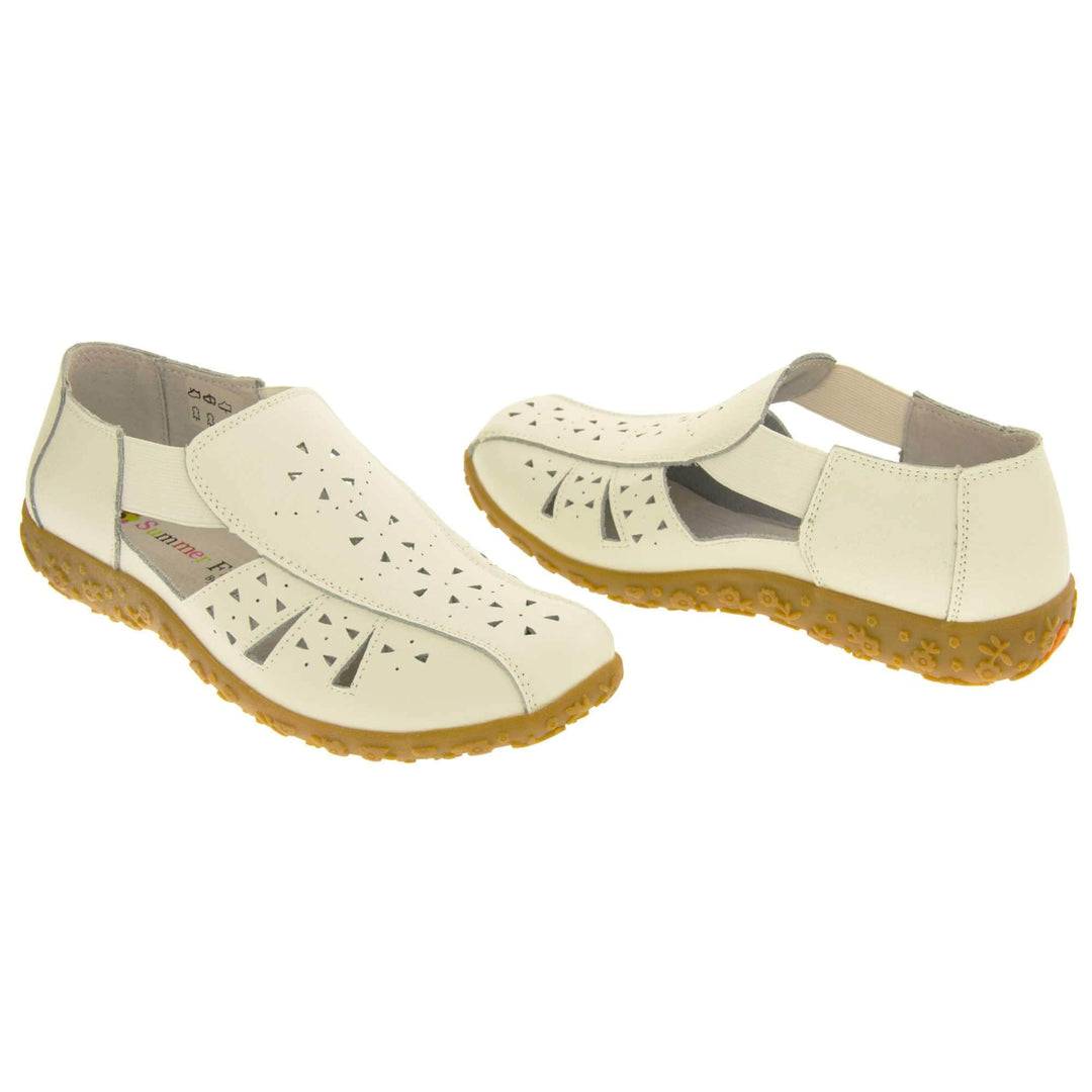 Womens white sandals. White leather closed toe sandals with white stitched detailing. With small cut out details on the upper. White elasticated strips from tongue to ankle to allow more room for a better fit. Cream coloured leather insole and lining. Brown sole with heel having a slight platform with raised flower design for grip. Both feet at a slight angle facing top to tail.