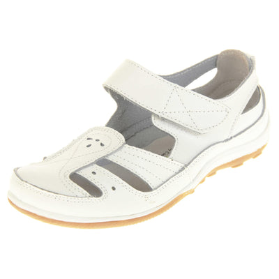 Womens white strap sandals. Mary Jane style shoes. White leather uppers with white stitching detail. White touch fasten strap over the foot. Cut outs in the middle, edges and heel of the shoes. Beige sole with grip to the bottom. Left foot at an angle.
