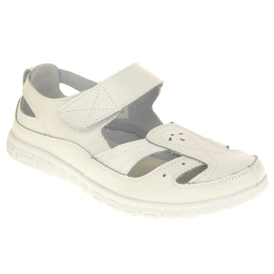 Womens white wide fit sandals. Mary Jane style shoes. White leather uppers with white stitching detail. White touch fasten strap over the foot. Cut outs in the middle, edges and heel of the shoes. White sole with grip to the bottom. Right foot at an angle.