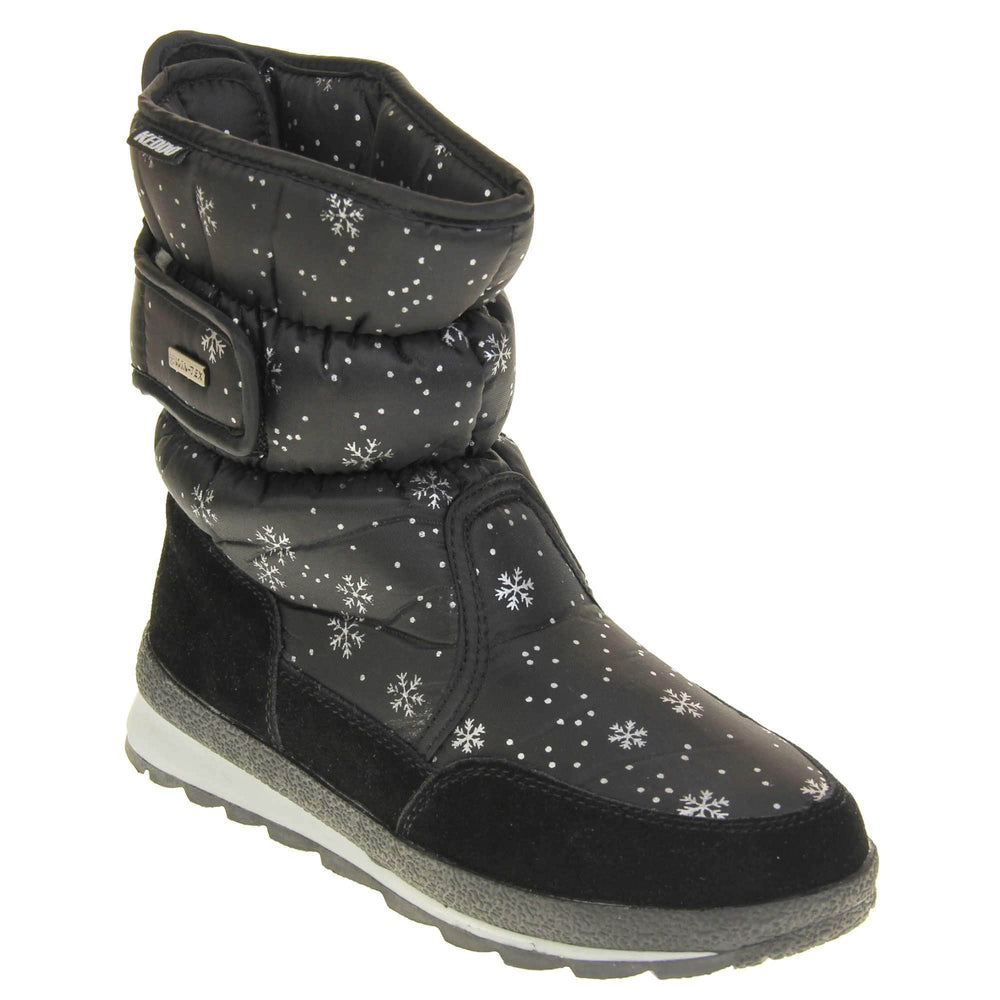 Womens Winter Boots. Black textile upper with snowflake and dots pattern on in white. Black faux-suede edging to the bottom of the boot . Grey and white chunky sole with good grip. Faux fur lining. Silver metal Win-Tex tag on the touch fasten strap, Keddo label along outside rim of the foot. Right foot at an angle.